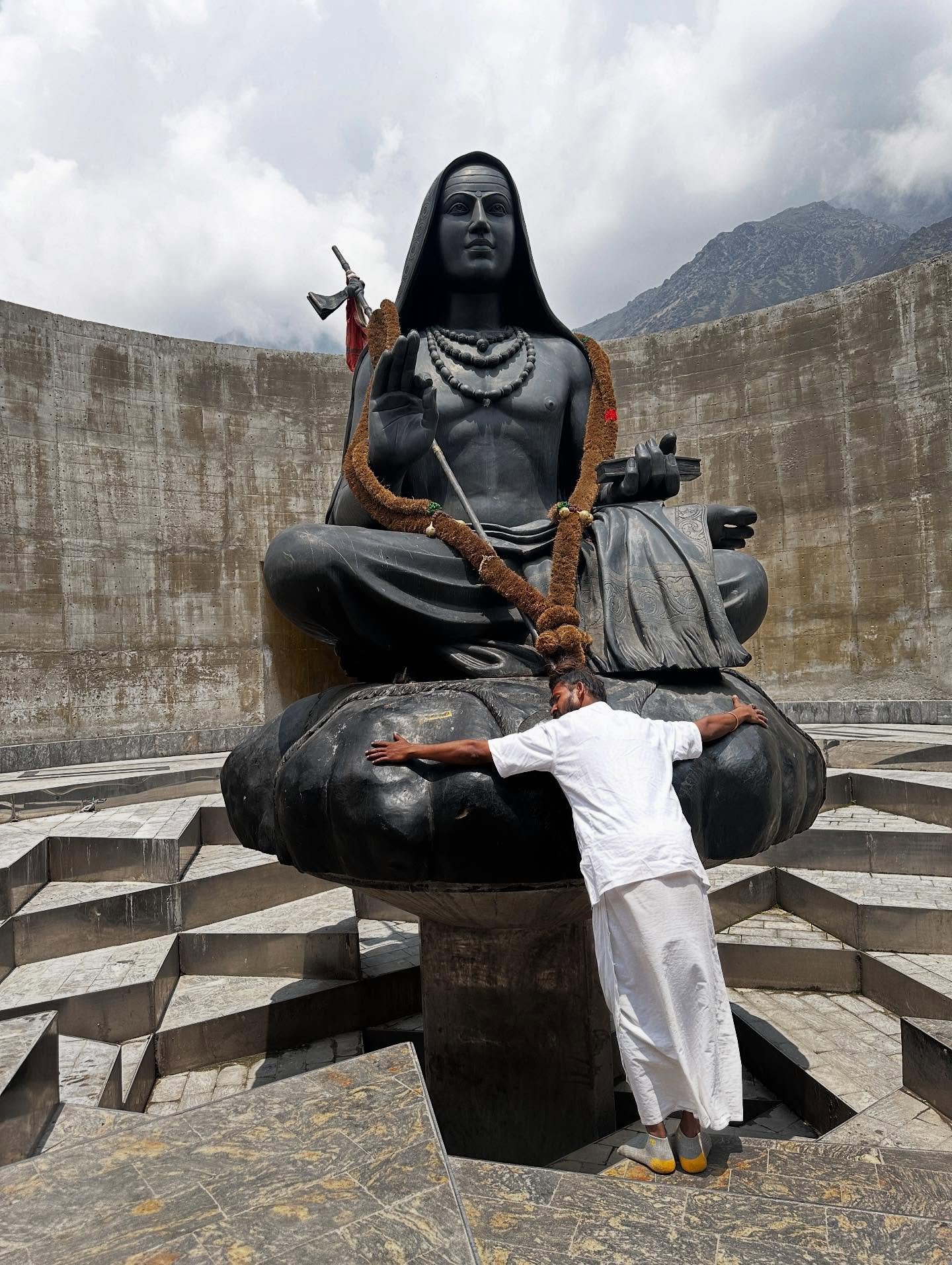 Bhavani Baba hugging a mountain statue in Kedarnath
